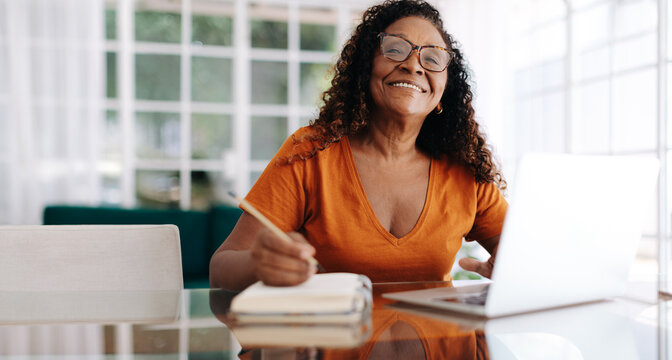 Mature woman planning her retirement at home
