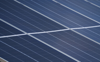 Wide angle selective focus concept photo with some big solar panels. Photovoltaic electrical energy industry, eco friendly way to produce electricity from sun.