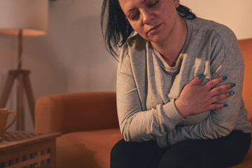 Fototapeta premium Woman with strong stomach ache and digestive issues at home.