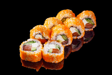 sushi roll with salmon cream cheese tobiko avocado and cucumber on a black mirror background