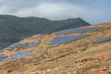 View of a sustainable farm, with large quantity of photovoltaic solar panels, for the production of green alternative energy, energy of the future, on Madeira Island, Portugal - obrazy, fototapety, plakaty