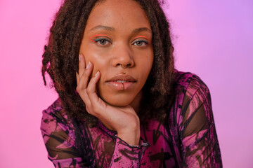 Portrait of young woman wearing pink eyeliner