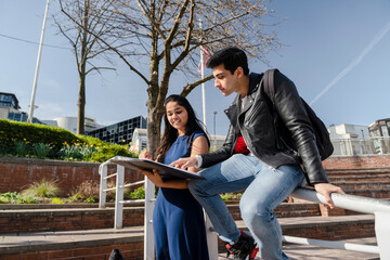 Fototapeta premium Smiling young students studying on campus