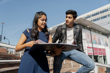 Fototapeta premium Smiling young students studying on campus