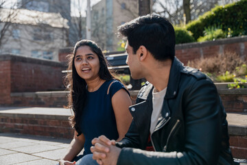 Smiling young student talking on campus