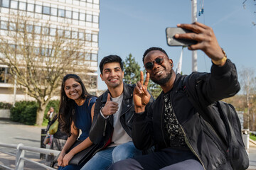 Group of friends taking selfie on campus