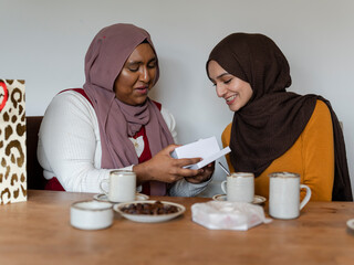 Woman looking at gift with friend