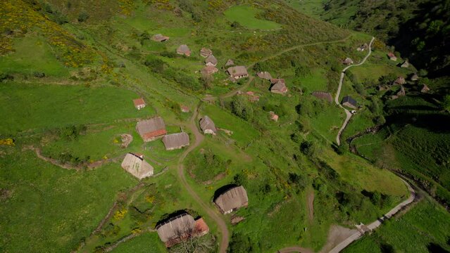 Drone flying over remote rural hamlet composed of huts for the old transhumance