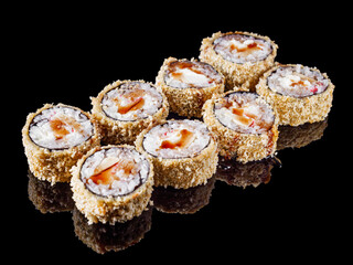 hot sushi roll tempura with eel shrimp crab salmon cream cheese cucumber avocado unagi on a black mirror background