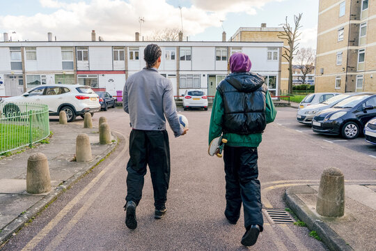 Young male friends walking outdoors - Powered by Adobe