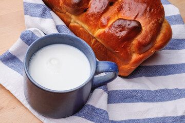 Fresh pastries and a blue cup of milk on a towel
