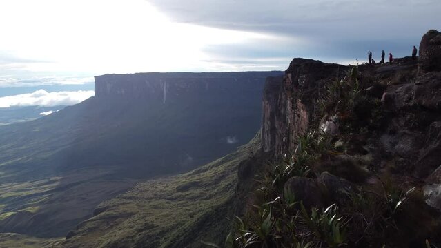 Drone flying over the top of Tepui Roraima mountain in Venezuela with people visiting it