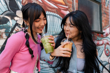 Young women drinking sweet drinks