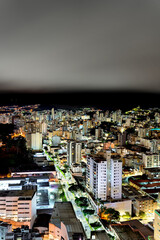 Vertical long exposure of illuminated city with cloudy sky