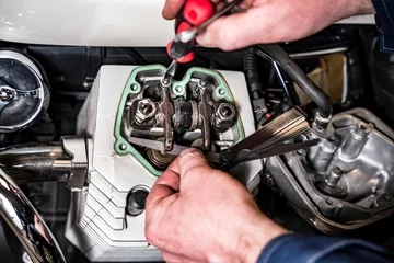Fotobehang adjusting engine valves of motorcycle at the workshop © Андрей Знаменский