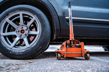  car is jacked using an automobile hydraulic jack
