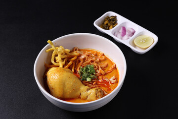 Khao Soi Thai Curry soup isolated in black background