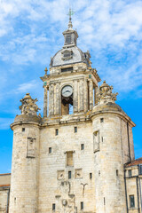 Fototapeta na wymiar Grosse-Horloge tower in La Rochelle, France on a sunny day of summer