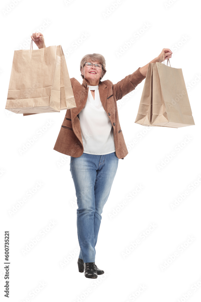 Wall mural mature woman holding bags smiling and looking at camera