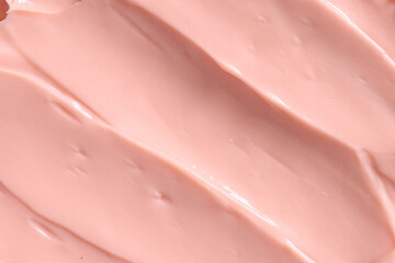 Fototapeta premium Pink skin care cosmetic beauty cream texture background in close up