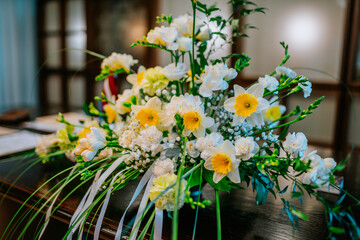 a bouquet of daffodils stands on the table as a decoration