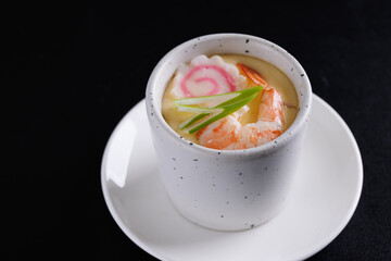Japanese Traditional food Eggs Custard Chawanmushi isolated in black background