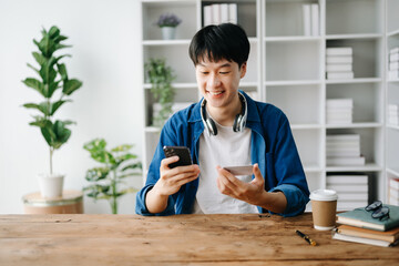 Man using smart phone for mobile payments online shopping,omni channel,sitting on table