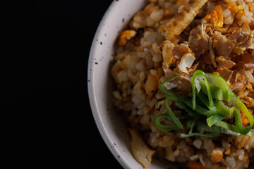 Japanese fried rice yakimeshi isolated in black background