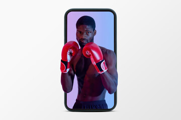 Confident muscular black guy with naked torso and boxing gloves on phone screen