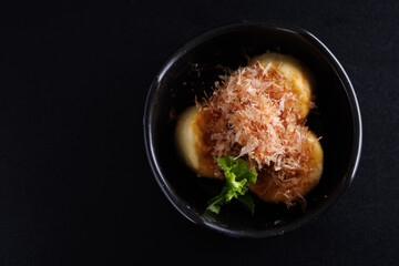 Japanese tofu Japanese appetizer soft cold tofu with sauce ginger and green onion topping isolated in black background