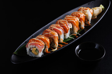 Salmon Sushi roll Japanese food isolated in black background