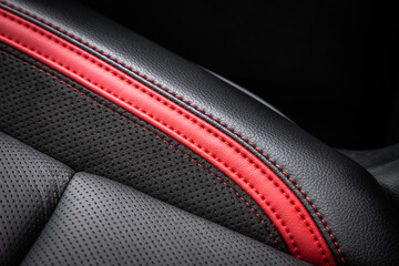 close-up black and red  perforated leather car seat. Skin texture