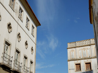 Old house shabby facades with windows against blue clear evening sky in Elvas, Portugal