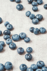 Fresh blueberries scattered on a linen napkin.