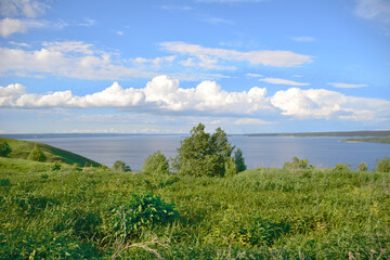 Fototapeta na wymiar A view of the lake with cloudscape and the horizon line in the distance, copy space