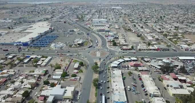 View from a drone flying still over the city of Mexicali showing far away a monument of the mexican ex-president Francisco Zarco in the middle of a roundabout
