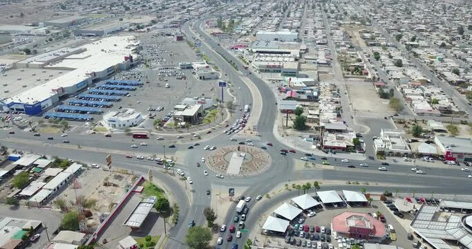 View from a drone flying away from a monument of the mexican ex-president Francisco Zarco in the middle of a roundabout in the city of Mexicali