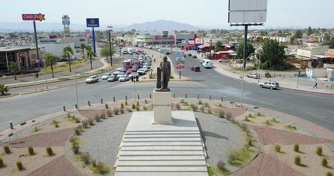 View from a drone flying back from a monument of the mexican ex-president Francisco Zarco in the middle of a roundabout in the city of Mexicali
