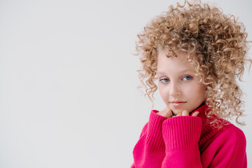 girl in a pink sweater and afro curls, beauty and fashion