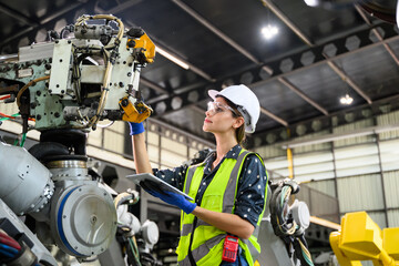 Female business owner engineer managing and checking work at factory