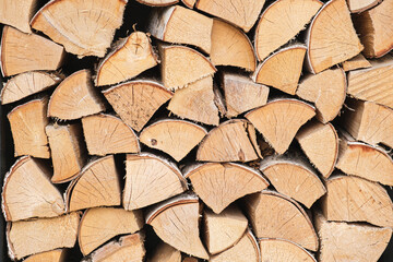 Woodpile lies in a heap, chopped for burning in a furnace. Finely chopped and stacked firewood. Background of stacked chopped wood logs.