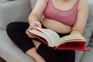 Overweight woman reading book for lose weight. Fat woman worried about weight diet Lose weight lifestyle