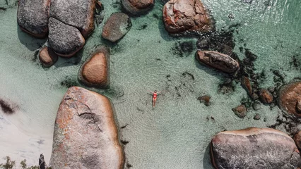 Foto auf Alu-Dibond Aerial picture of a girl swimming in a fairy pool in Albany, Australia. Shallow and transparent water. Drone picture. Swimming in paradise in a lagoon between rocks. © Elsa