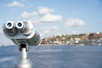 A telescope on the Volga River, looks at the river and the opposite bank, which are in full focus