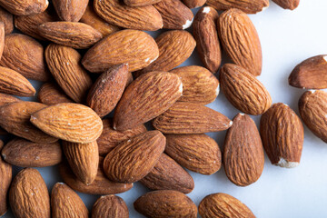 Pile of almonds seeds on a marble background. Fresh almonds nut.