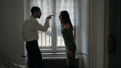 Candid couple fighting, man pointing finger blaming for problems, pushing her away and girlfriend hitting back on boyfriend face. Woman slapping guy. Relationship in crisis