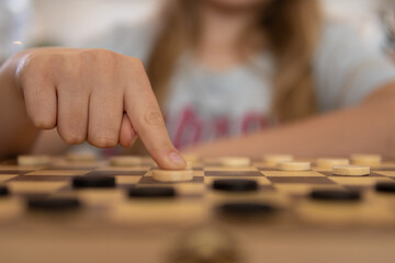 Fototapeta premium close-up view of a hand of elderly woman playing chess.