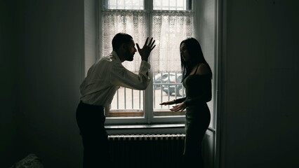 Angry man shouting at woman. Dramatic scene of couple yelling at each other in dispute. People...