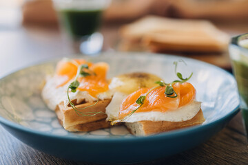 Waffles with egg, salmon and microgreens.Delicious and healthy breakfast food concept.Close-up,selective focus.