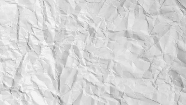 Crumpled sheet of paper close up, moving from left to right